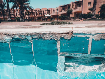 View of swimming pool by sea against buildings