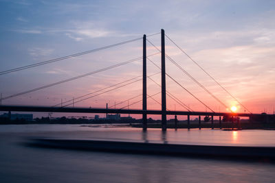 View of suspension bridge against sky during sunset