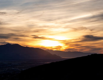 Scenic view of silhouette mountains against sky during sunset