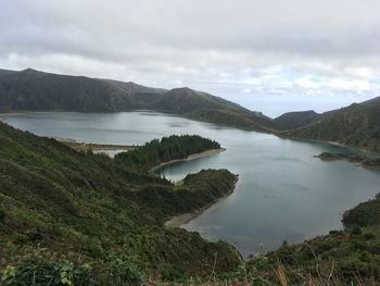 Scenic view of lake and mountains against sky