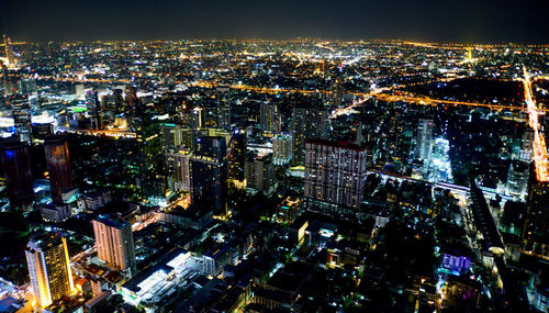 High angle view of illuminated city buildings at night