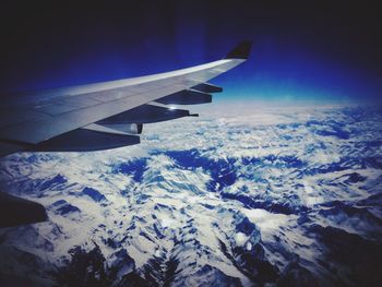 Cropped image of airplane flying over landscape