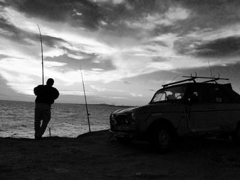 Man standing by sea against sky