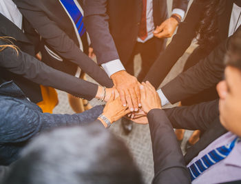 High angle view of business people stacking hands