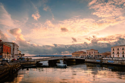 Bridge over river against sky during sunset