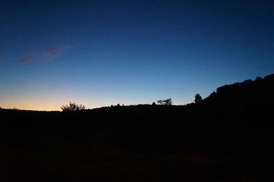 Silhouette landscape against clear sky
