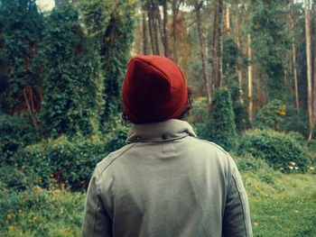 Rear view of man standing in forest