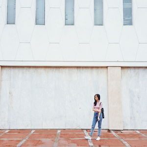 Full length of a woman standing in city