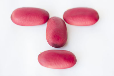 Close-up of multi colored candies against white background