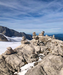 Rock formations by mountain against sky