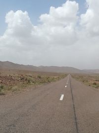 Road by landscape against sky