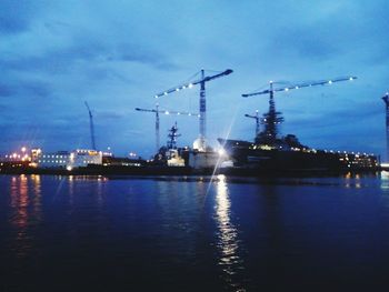 Illuminated commercial dock against sky at night