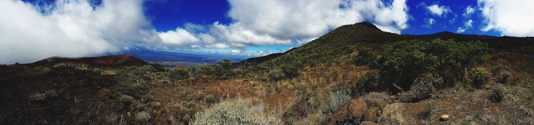 Scenic view of mountains against cloudy sky