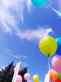 Low angle view of balloons against sky