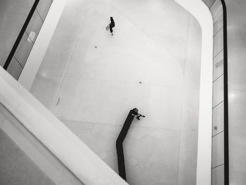 High angle view of man perching on dog