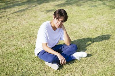 High angle view of woman sitting on grass