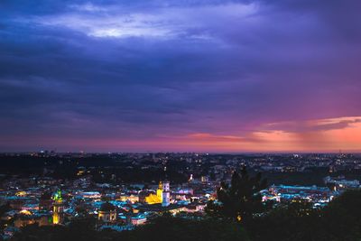 High angle view of illuminated buildings against sky at sunset