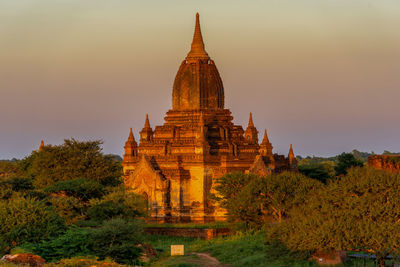 Temple against sky at sunset