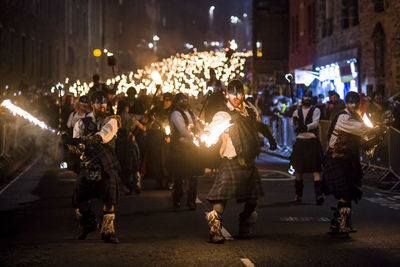 Group of people on street in city at night