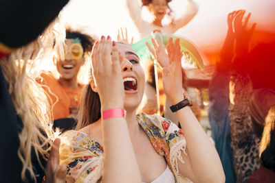 Female fan screaming in crowd at music concert