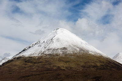 Scenic view of snow covered mountains against sky