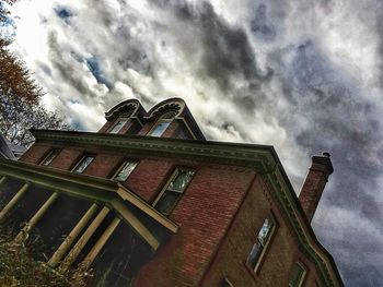 Low angle view of building against cloudy sky