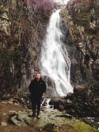 Woman standing on rocks in forest