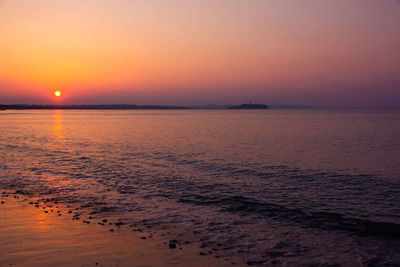 Scenic view of sea against romantic sky at sunset