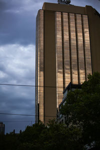Low angle view of building against cloudy sky