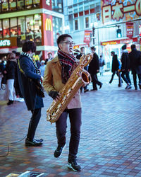 People playing on street in city