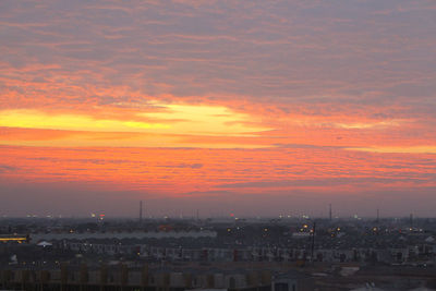 High angle shot of cityscape against dramatic sky