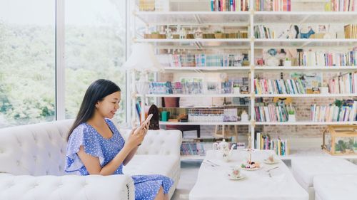 Full length of woman reading book