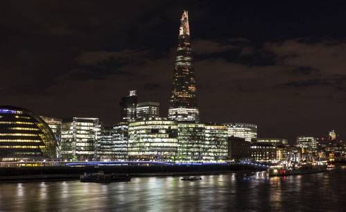 The shard and the city hall in london at night with light