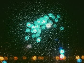Close-up of illuminated tree against sky at night