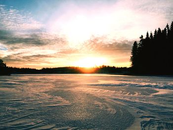 Scenic view of lake against sky during sunset