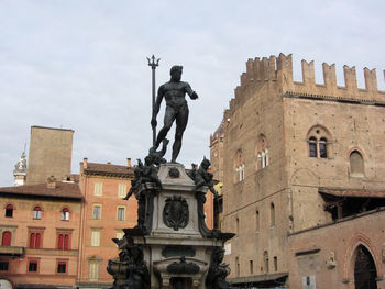 Low angle view of statue against historic building