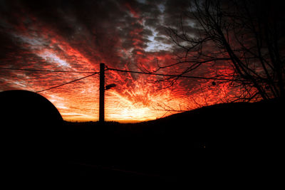 Silhouette trees against sky at sunset