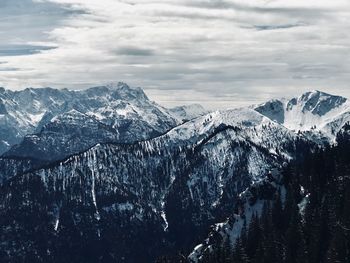 Aerial view of snowcapped mountains against sky