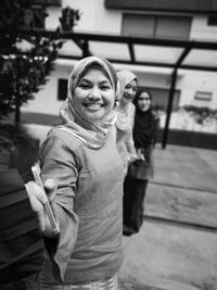 Portrait of smiling woman standing outdoors