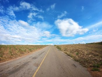 Empty road along countryside landscape