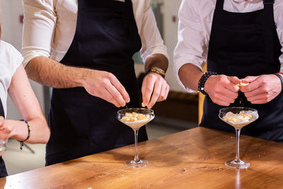 Midsection of woman preparing food at table