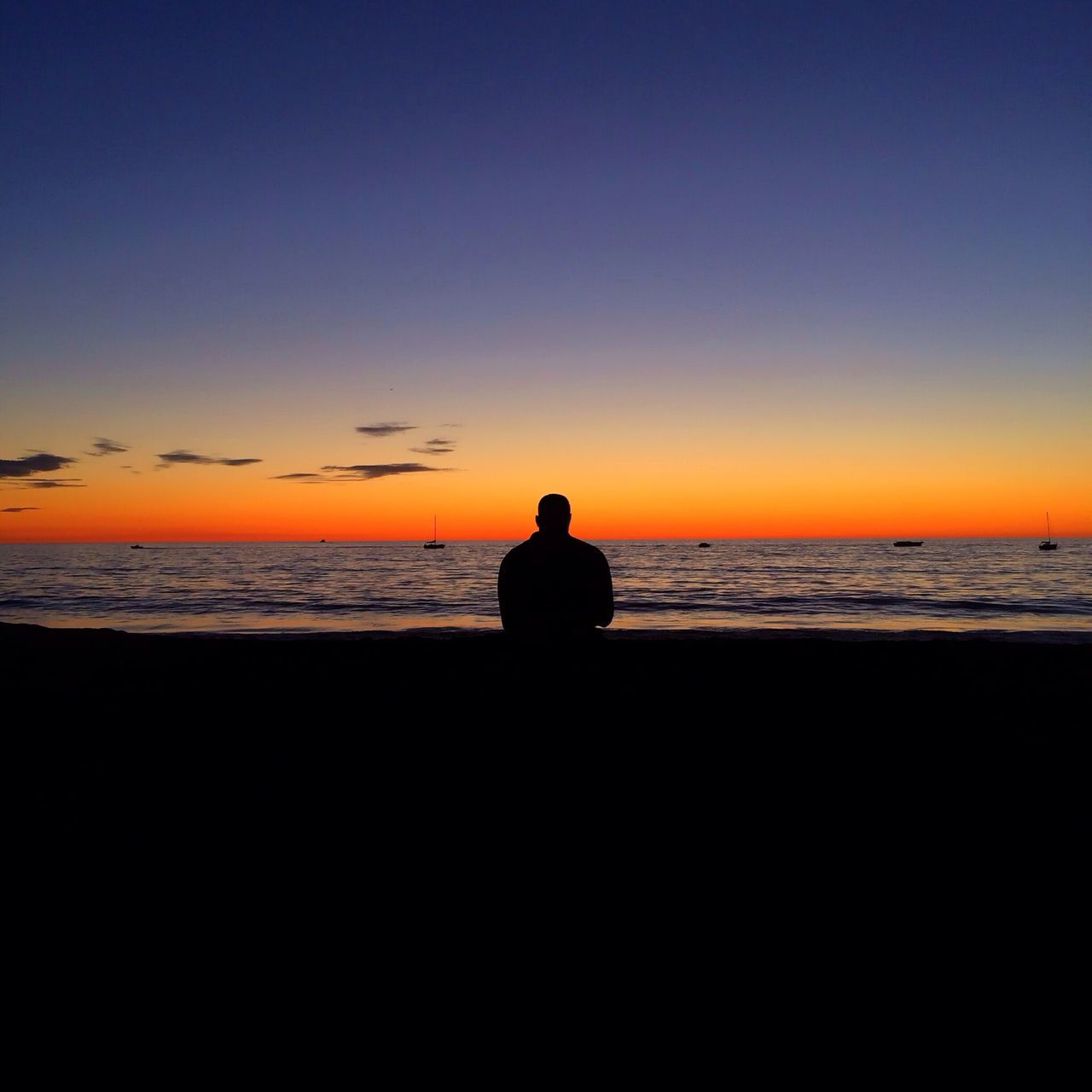 sunset, silhouette, sea, horizon over water, water, copy space, orange color, scenics, beach, tranquil scene, tranquility, beauty in nature, standing, lifestyles, leisure activity, sky, idyllic, clear sky