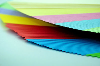 Close-up of multi colored papers on table