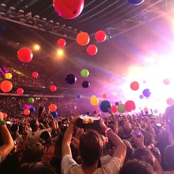 People enjoying with balloons at music concert