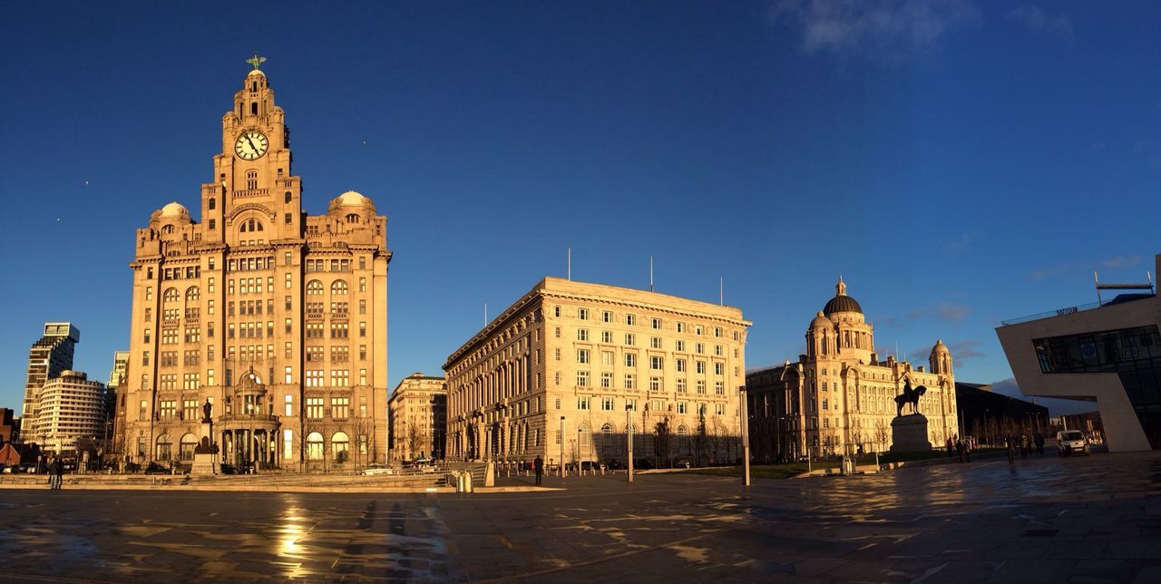 architecture, building exterior, built structure, clear sky, blue, water, famous place, travel destinations, history, copy space, city, tower, tourism, capital cities, travel, international landmark, sunlight, sky, outdoors, waterfront