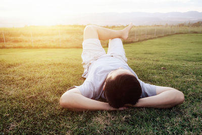 Mature man relaxing on grassy field