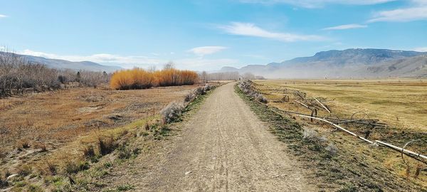 Dirt road along countryside landscape