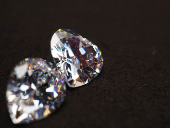 Close-up of ring on table against black background