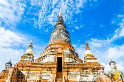 Low angle view of pagoda against cloudy sky