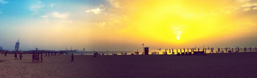 Panoramic view of beach against sky during sunset